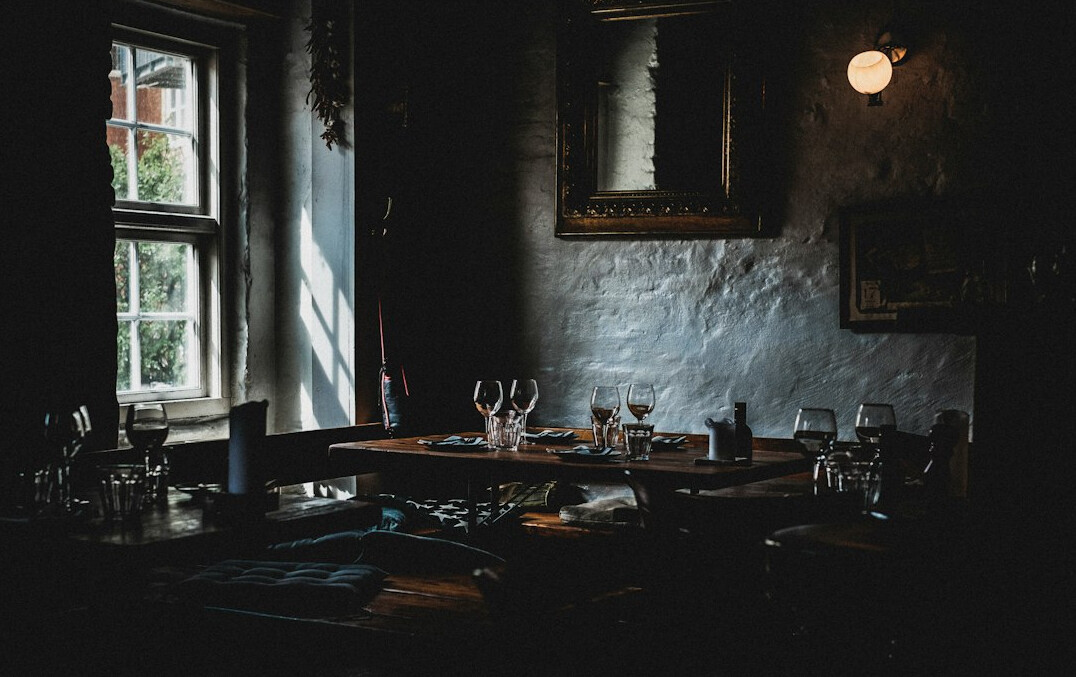 Danish family gathered around a table with candles indoors